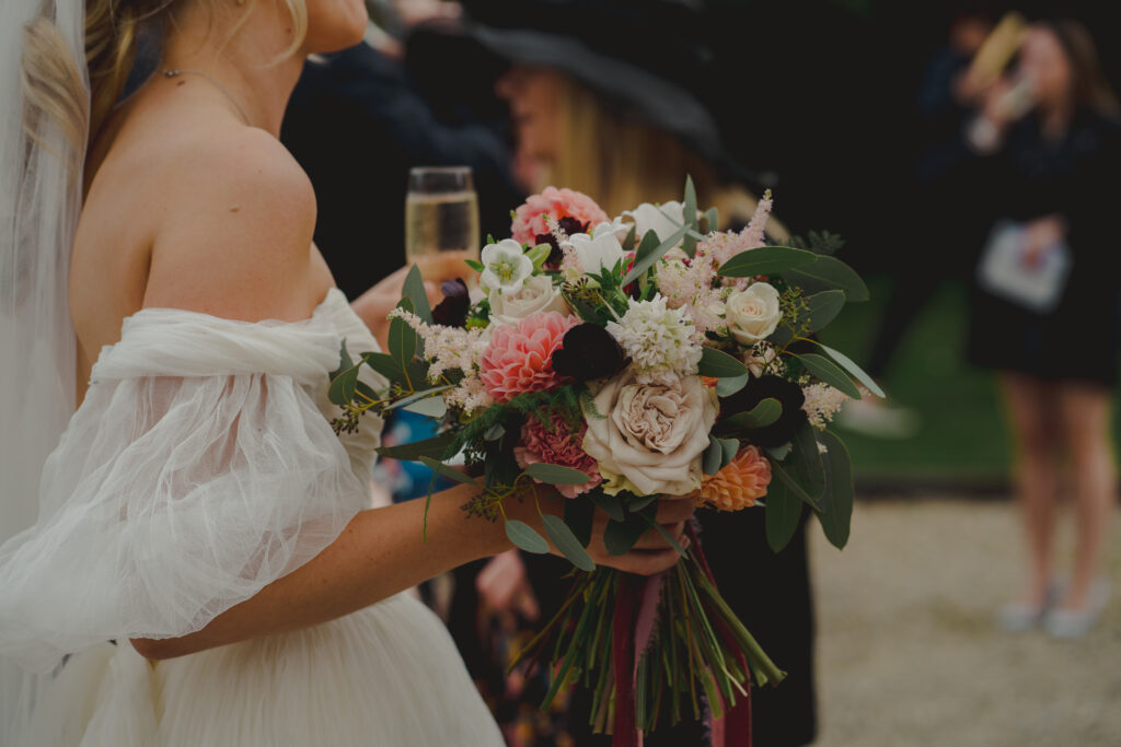 what we offer header image - bride holding bouquet and champagne