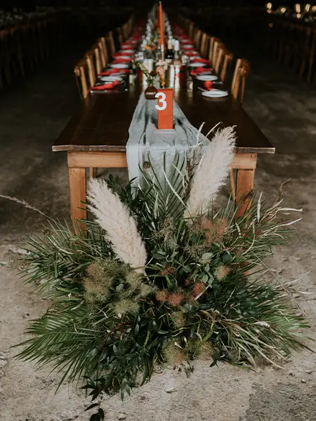 Jocelyn-Hughes-Flower-Company-Wedding-Flowers-Insert_Special1 end of table arrangement full of mixed foliage and pampas grass